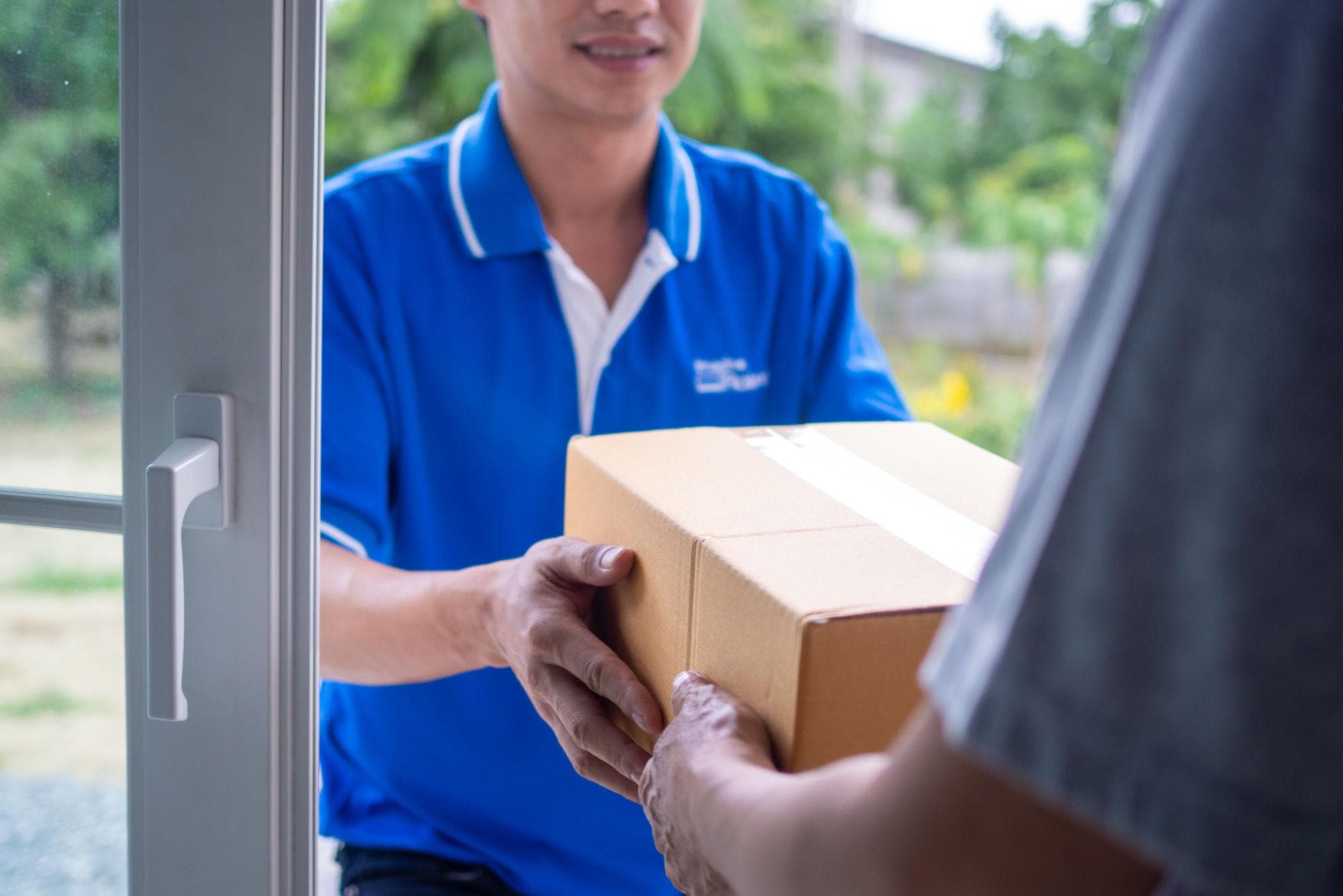 Courier loading parcels into a delivery van